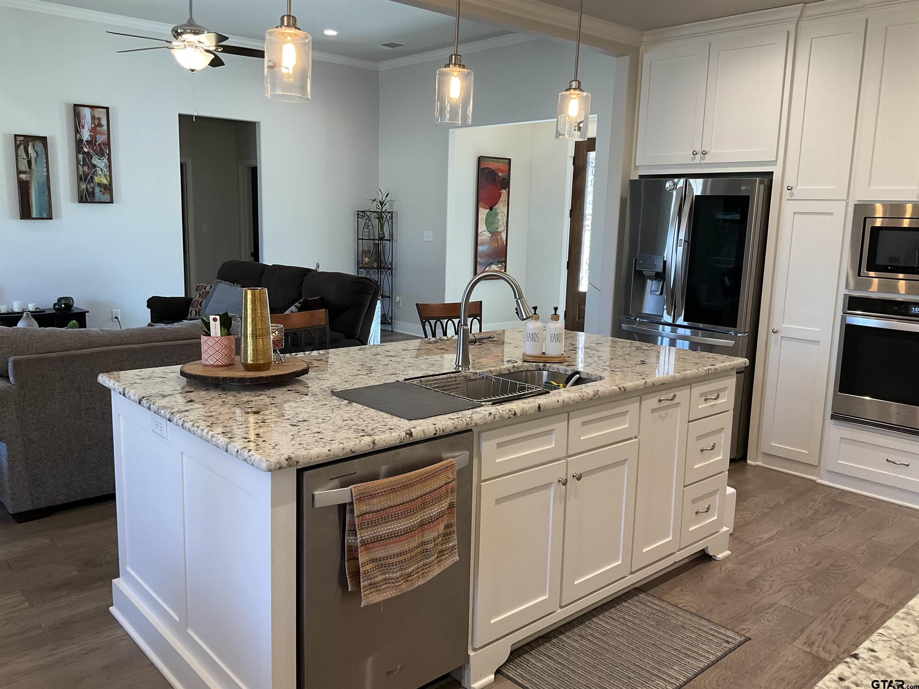 11978 Gillian Court Tyler, TX 75703 - Photo 13 of 36 a kitchen with stainless steel appliances granite countertop a sink and a refrigerator