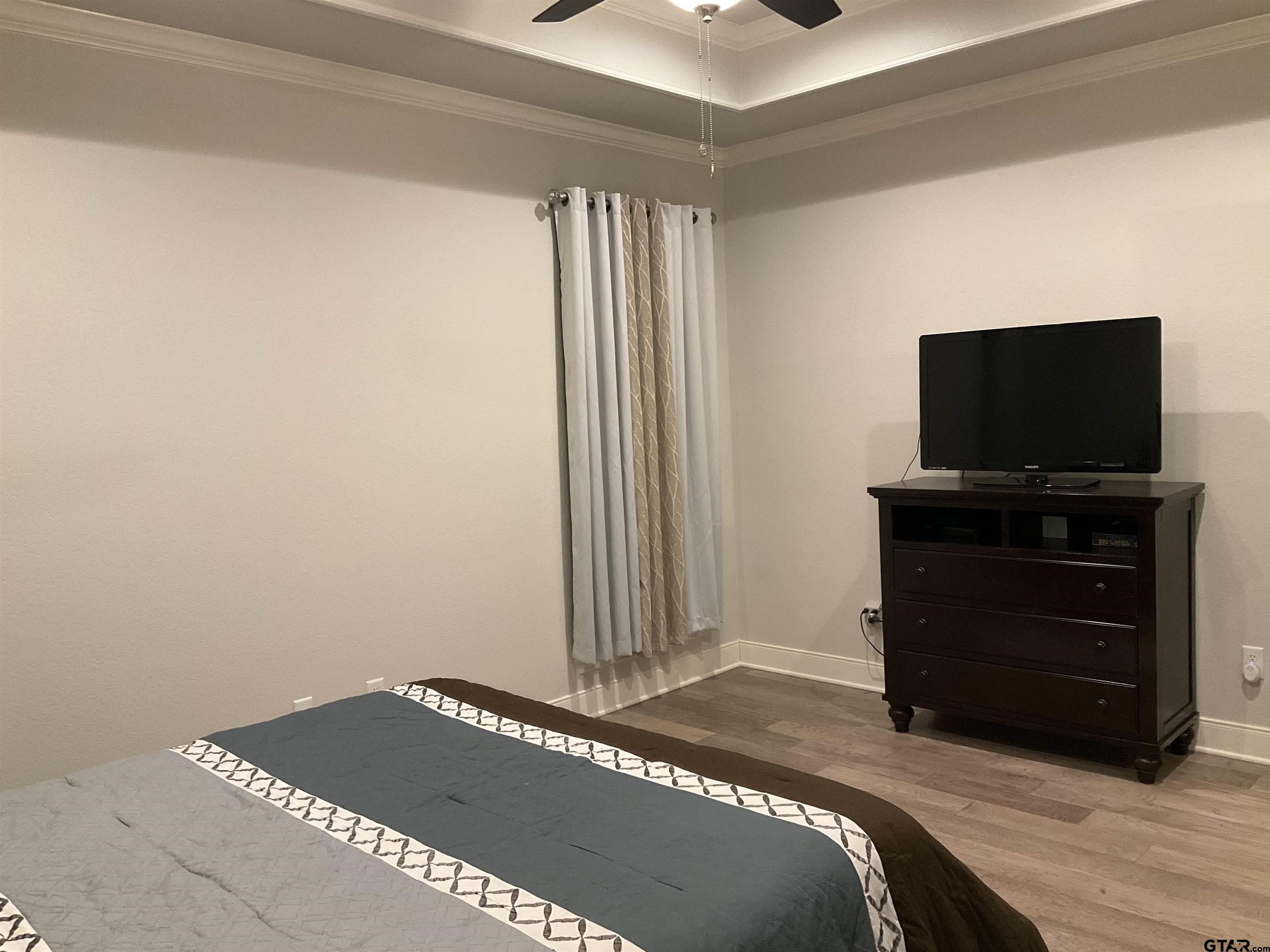 11978 Gillian Court Tyler, TX 75703 - Photo 15 of 36 a bedroom with a bed and flat screen tv