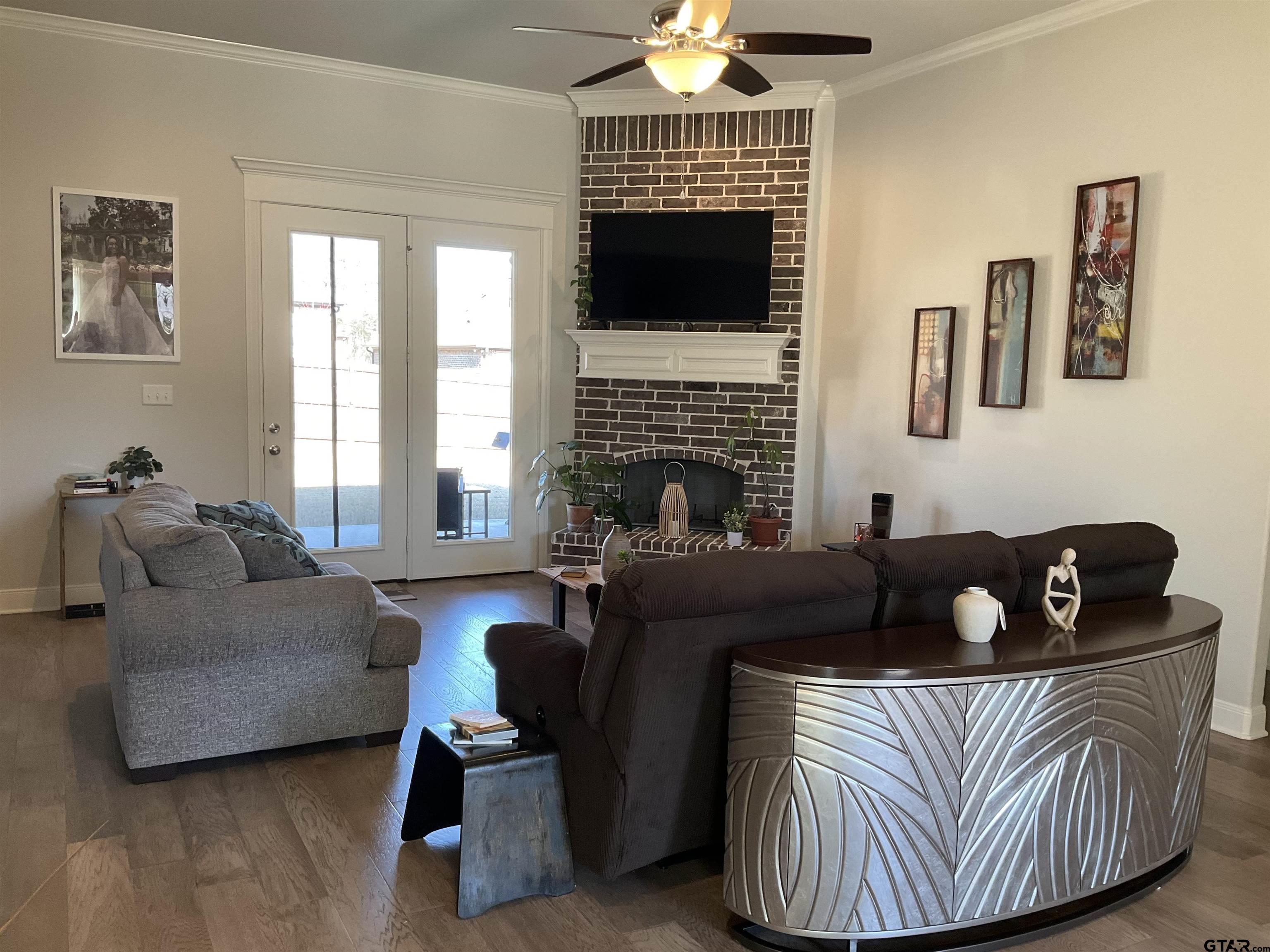 11978 Gillian Court Tyler, TX 75703 - Photo 2 of 36 a living room with furniture and a fireplace