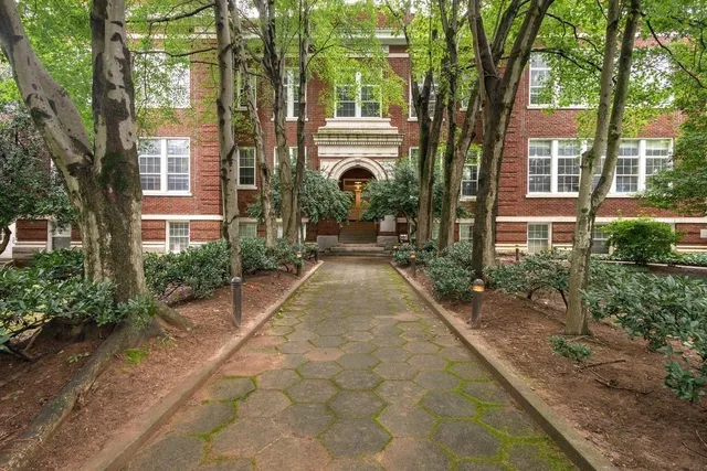 a very nice looking house with a large windows and a large tree