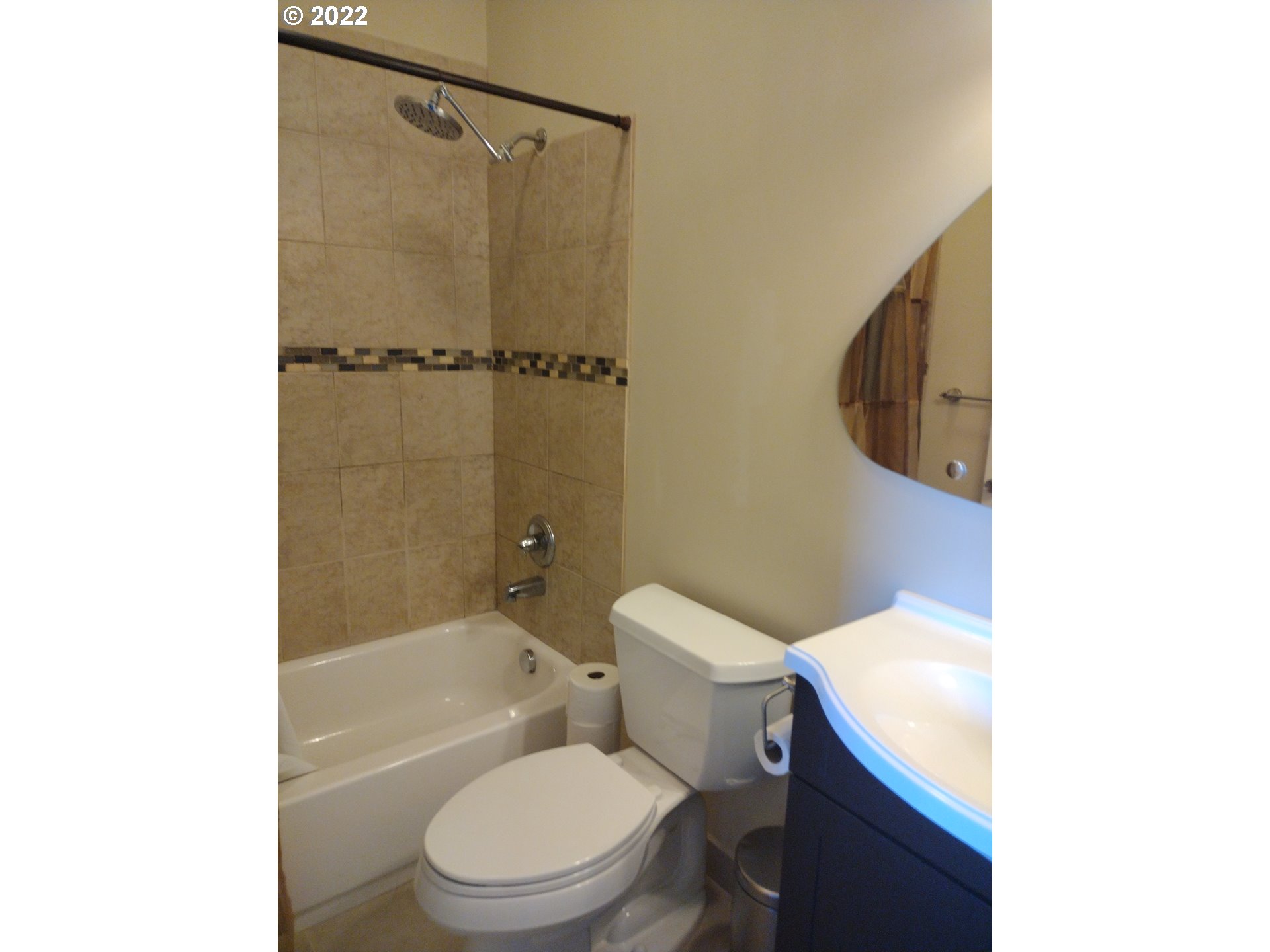 18024 Southeast Marie Street Portland, OR 97236 - Photo 13 of 31 a white toilet sitting next to a bathroom sink and a shower