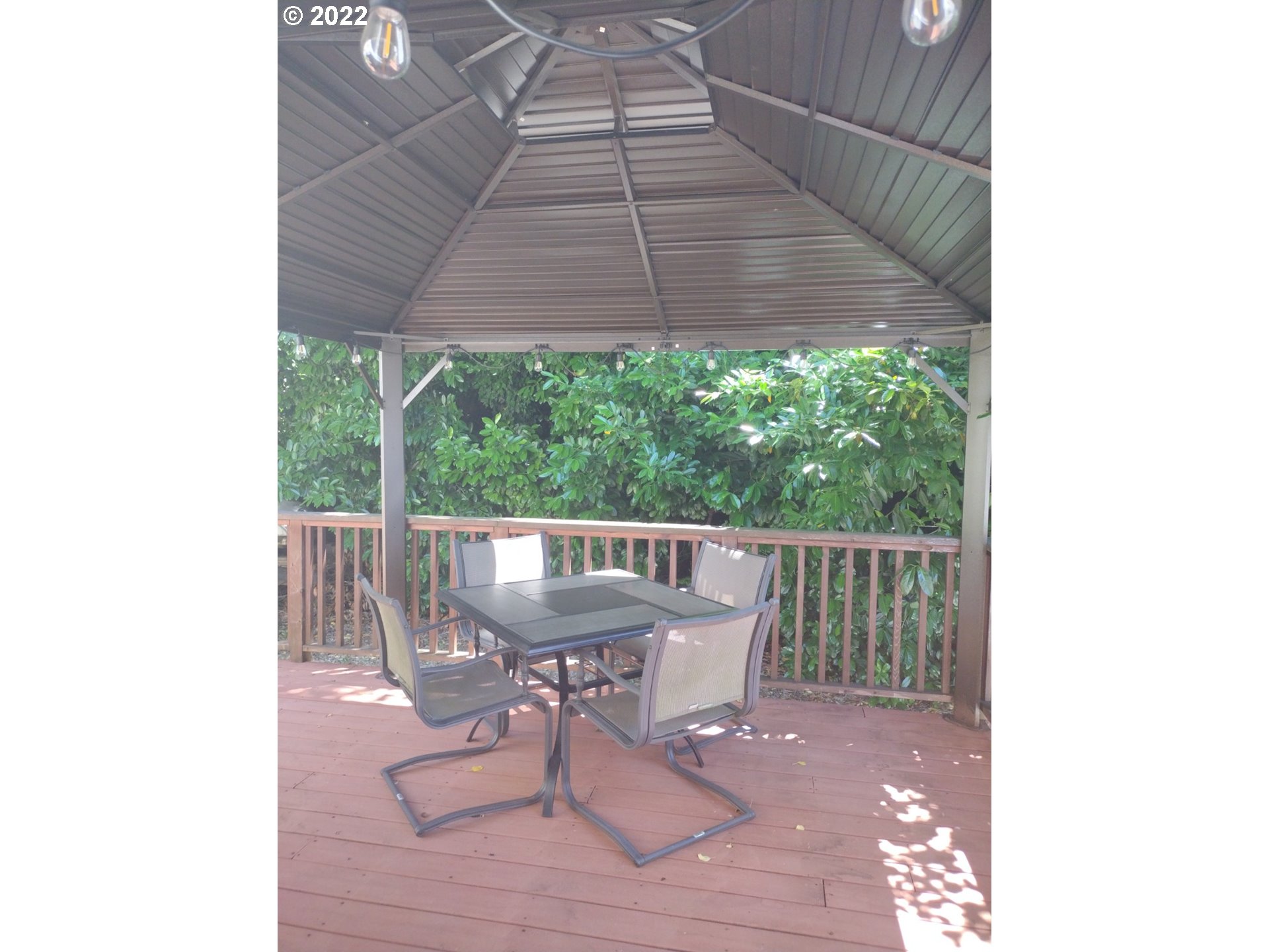 18024 Southeast Marie Street Portland, OR 97236 - Photo 21 of 31 a roof deck with table and chairs and wooden floor