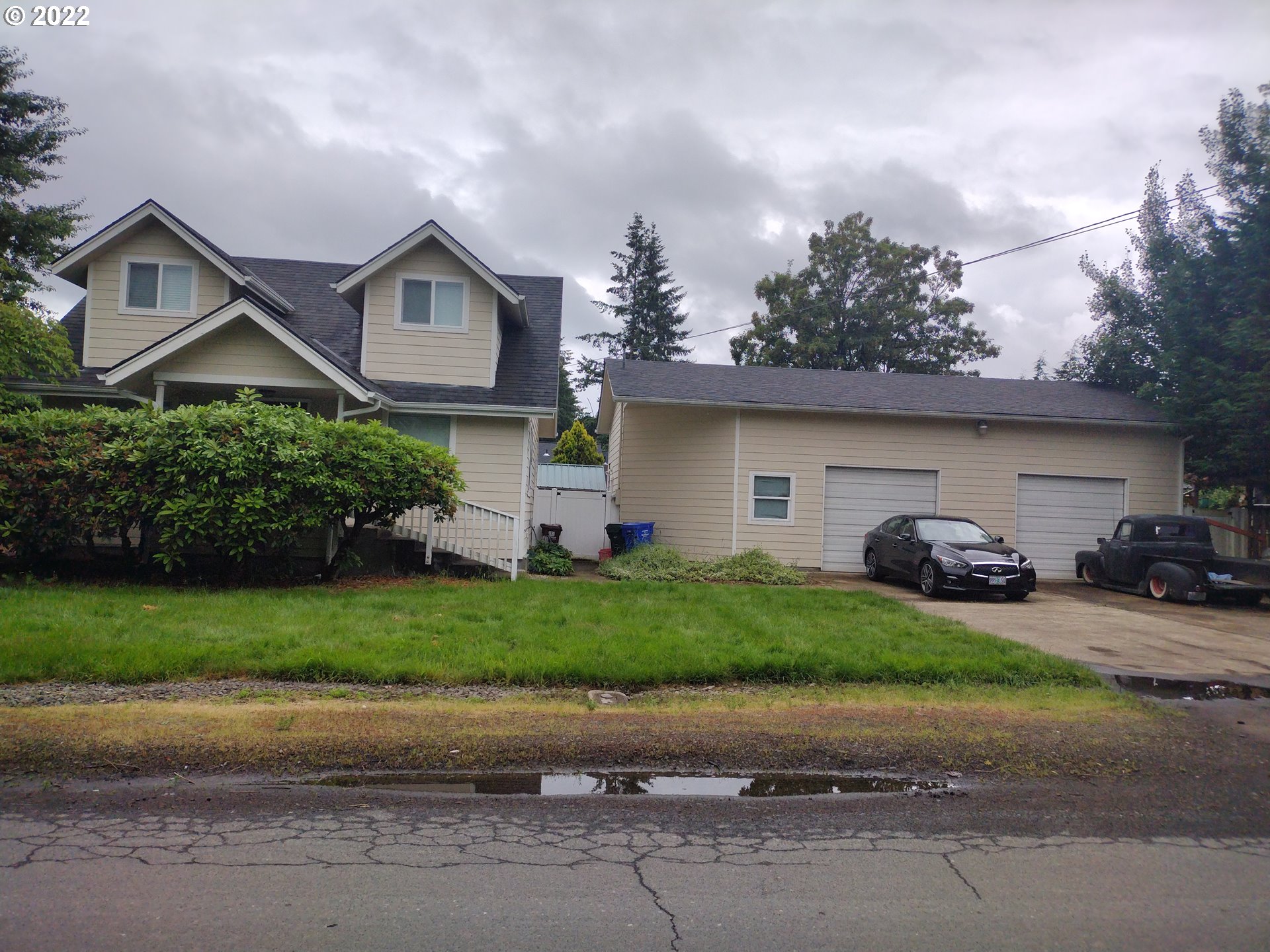 18024 Southeast Marie Street Portland, OR 97236 - Photo 30 of 31 a front view of a house with a yard and garage