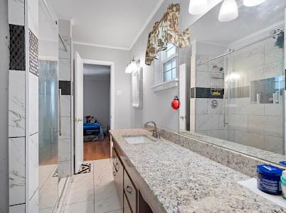 2133 Pleasant Drive Dallas, TX 75227 - Photo 21 of 40 Full bathroom featuring a stall shower, vanity, crown molding, and light marble finish floors
