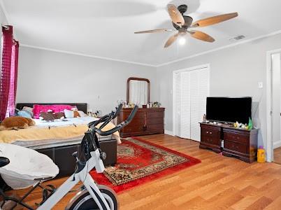 2133 Pleasant Drive Dallas, TX 75227 - Photo 22 of 40 Bedroom featuring ornamental molding, a closet, a ceiling fan, and wood finished floors