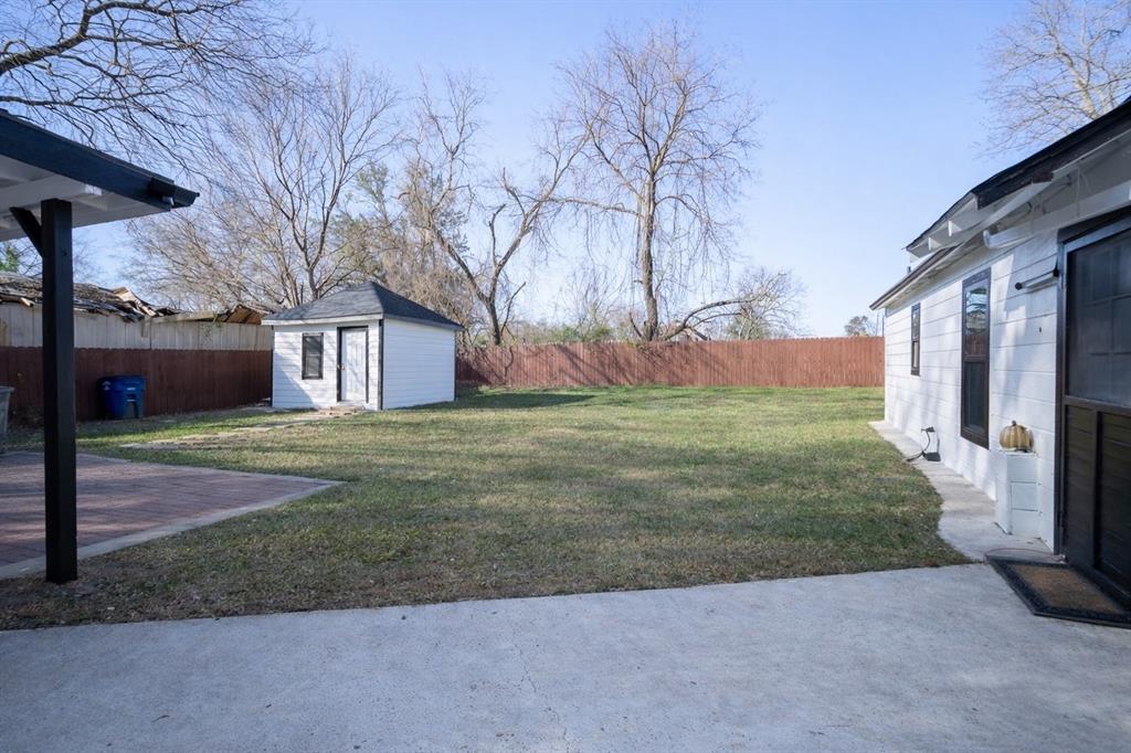2133 Pleasant Drive Dallas, TX 75227 - Photo 35 of 40 Fenced backyard with a patio and a shed