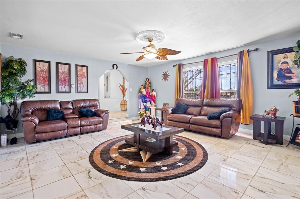 2133 Pleasant Drive Dallas, TX 75227 - Photo 6 of 40 Living room featuring arched walkways and a ceiling fan