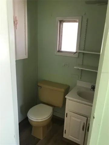 a white toilet sitting next to a window