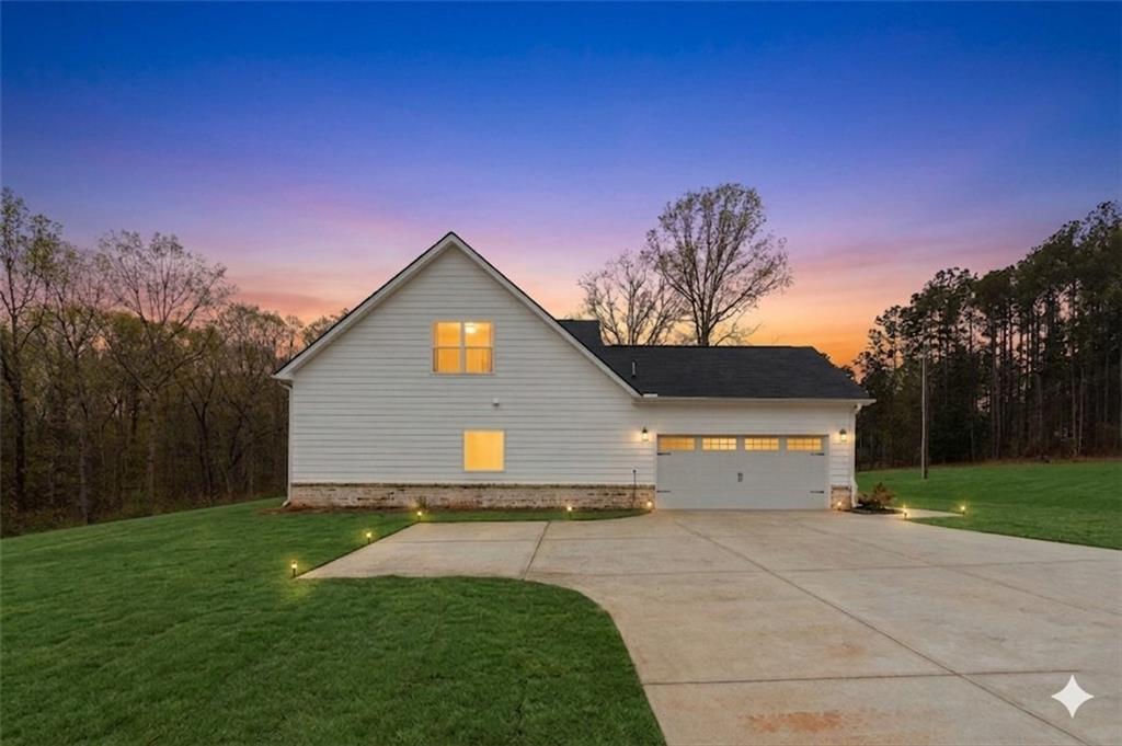 171 Strickland Loop Forsyth, GA 31029 - Photo 2 of 25 a front view of a house with garden