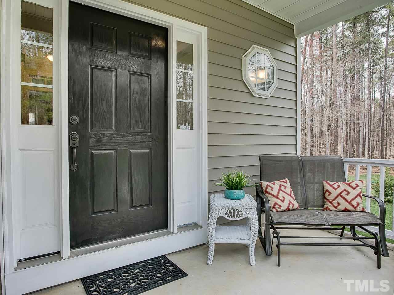 832 Kings Cross Way Raleigh, NC 27615 - Photo 2 of 25 a outdoor living space with furniture and a potted plant