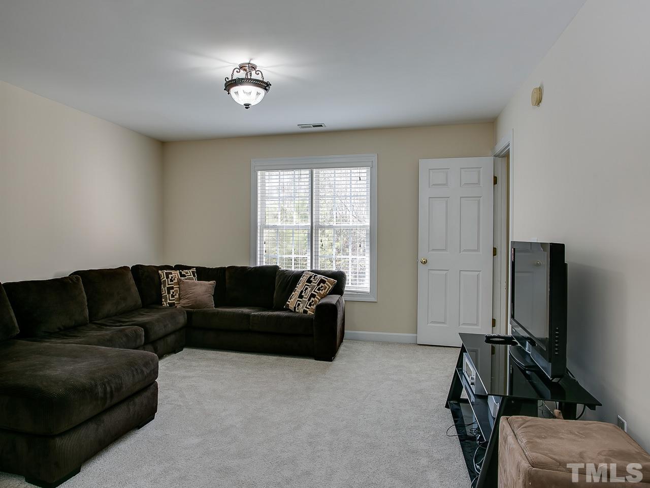 832 Kings Cross Way Raleigh, NC 27615 - Photo 14 of 25 a living room with furniture and a flat screen tv