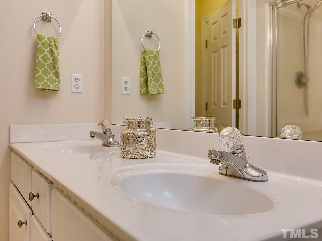 832 Kings Cross Way Raleigh, NC 27615 - Photo 18 of 25 a bathroom with double vanity sinks and a mirror