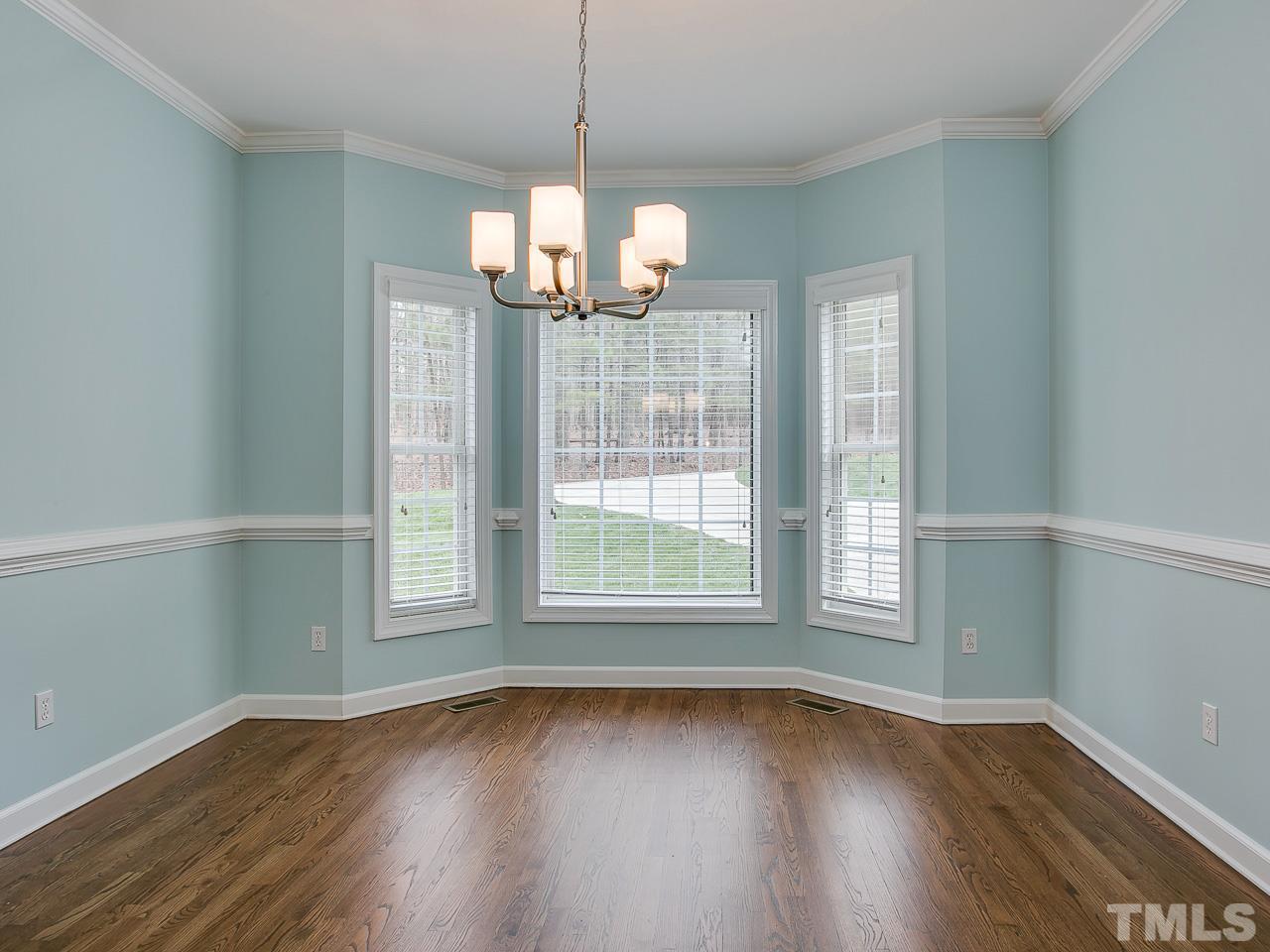 832 Kings Cross Way Raleigh, NC 27615 - Photo 4 of 25 a view of an empty room with wooden floor and a window