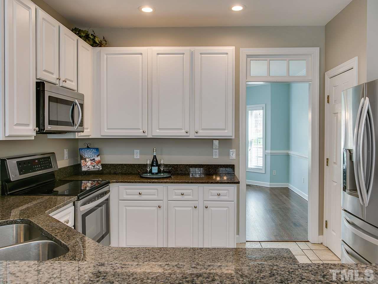 832 Kings Cross Way Raleigh, NC 27615 - Photo 6 of 25 a kitchen with granite countertop a sink a stove and refrigerator