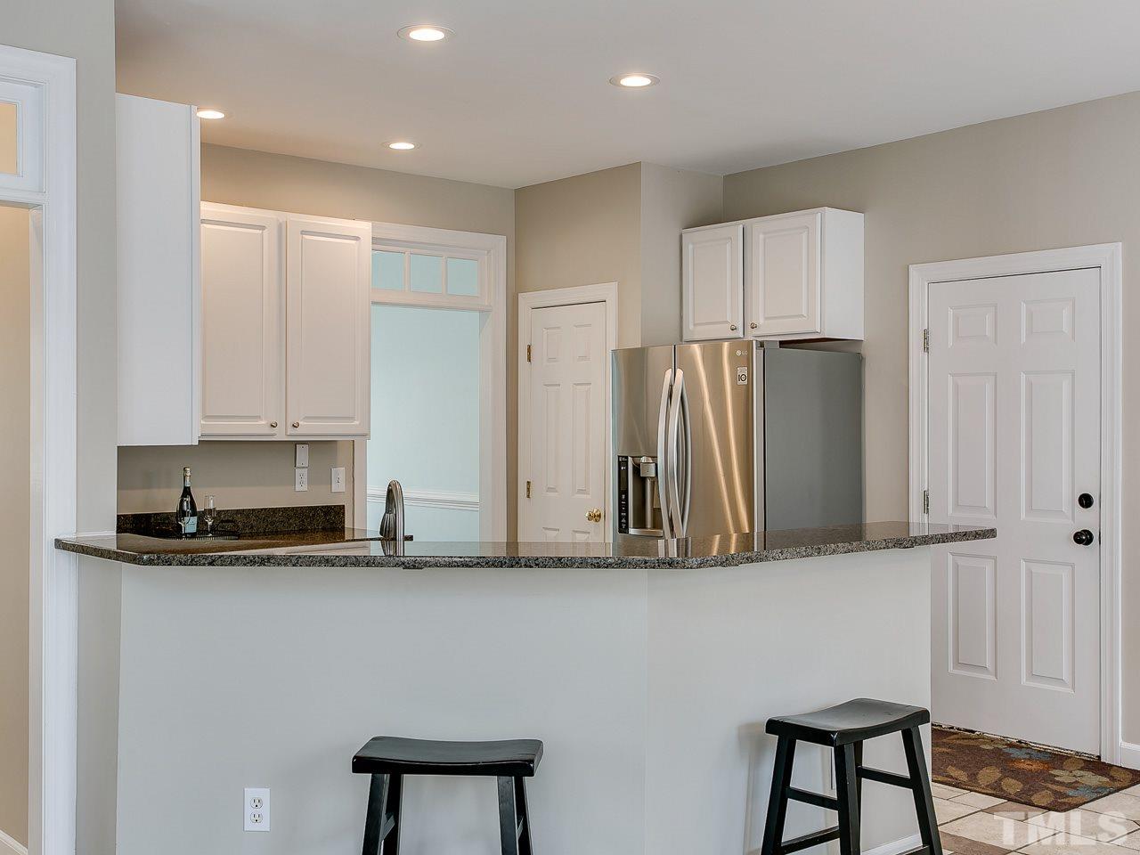 832 Kings Cross Way Raleigh, NC 27615 - Photo 7 of 25 a kitchen with stainless steel appliances granite countertop a refrigerator and a stove top oven