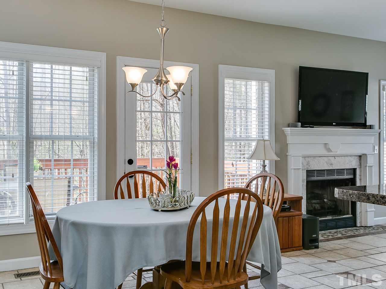 832 Kings Cross Way Raleigh, NC 27615 - Photo 8 of 25 a view of a dining room with furniture window and wooden floor