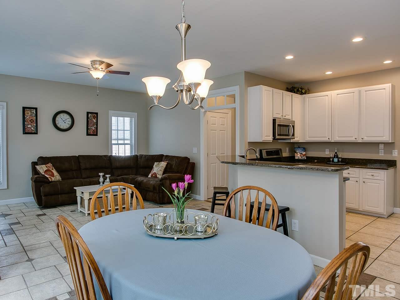 832 Kings Cross Way Raleigh, NC 27615 - Photo 10 of 25 a kitchen with stainless steel appliances granite countertop a dining table and chairs