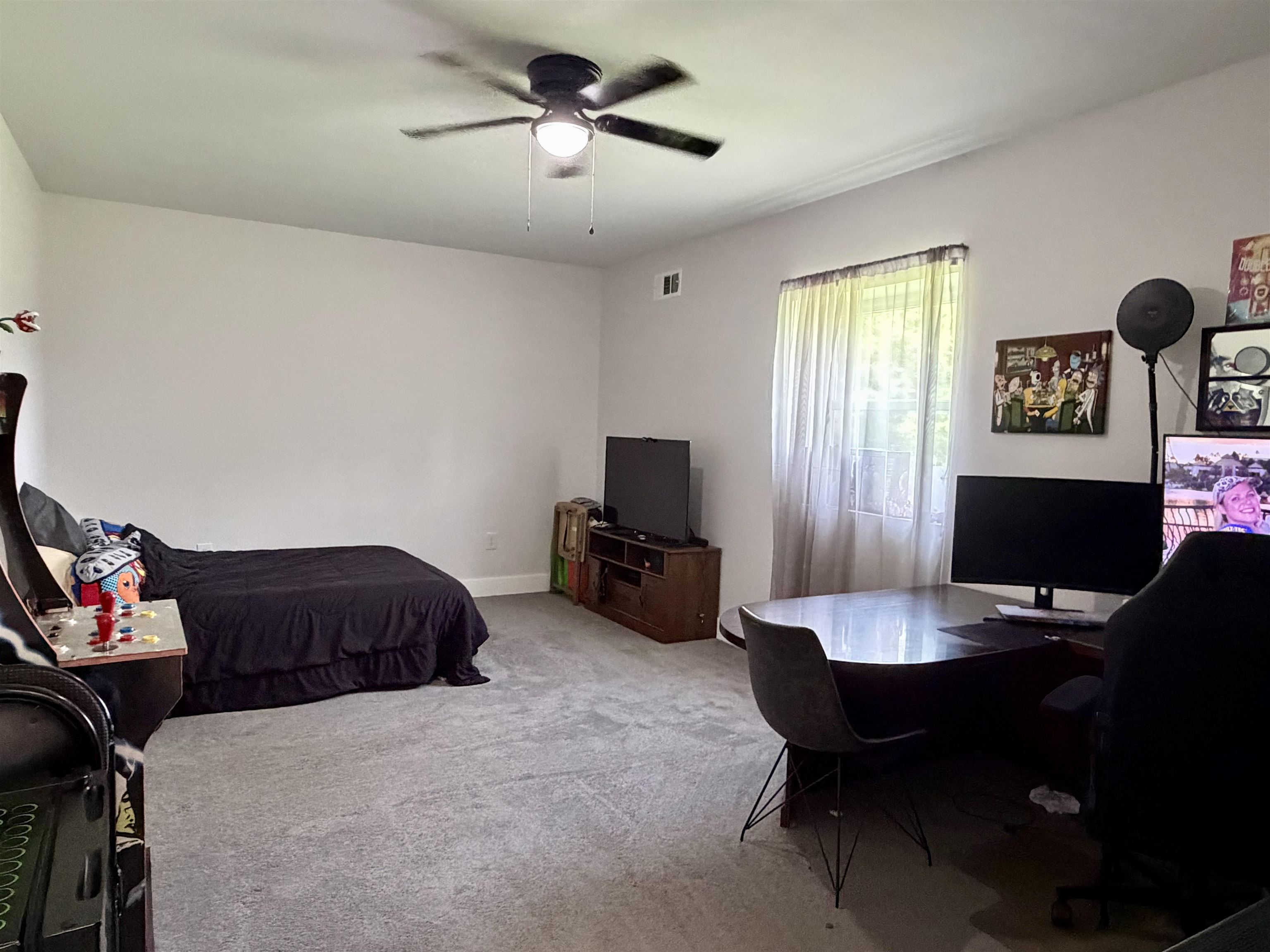 3670 Peavine Road Middleton, TN 38052 - Photo 23 of 36 Spacious room featuring light gray walls, textured gray carpeting, and a ceiling fan with integrated lighting