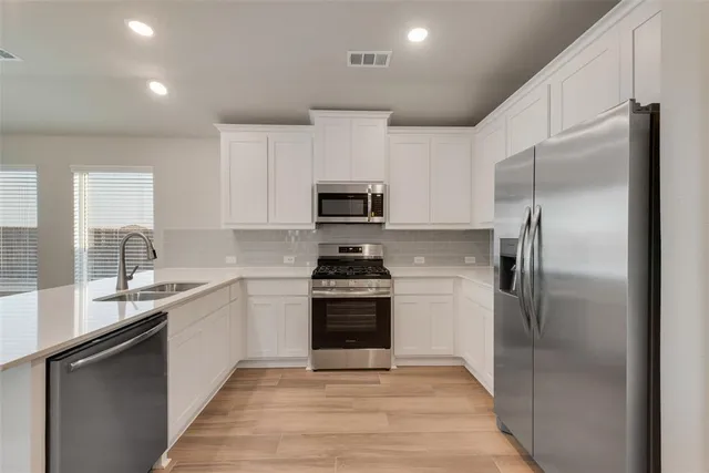 a kitchen with a sink stove and refrigerator