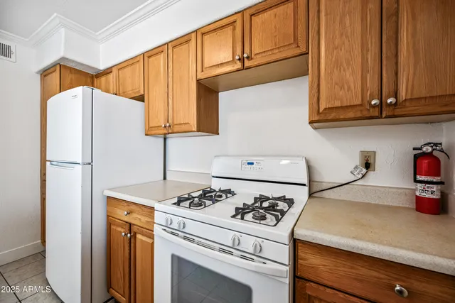 a kitchen with a refrigerator and a stove