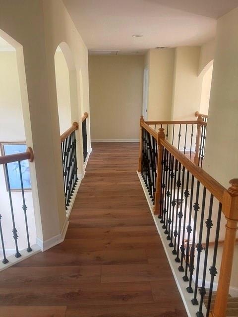 2123 Floral Ridge Drive Dacula, GA 30019 - Photo 30 of 56 a view of a hallway with wooden floor and stairs