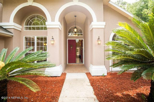 3541 Kings Road South St. Augustine, FL 32086 - Photo 3 of 39 a front view of a house with a garden