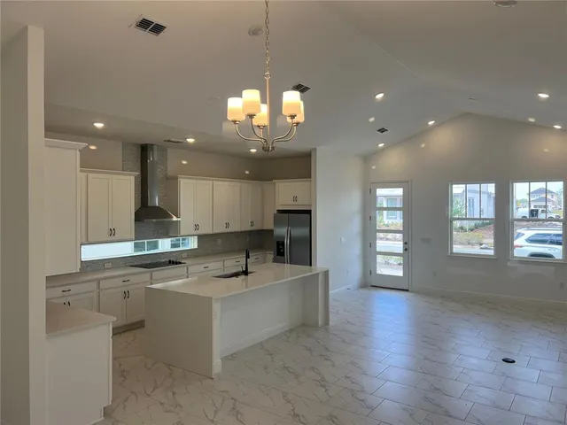 a view of a kitchen and kitchen with a sink wooden floor kitchen view