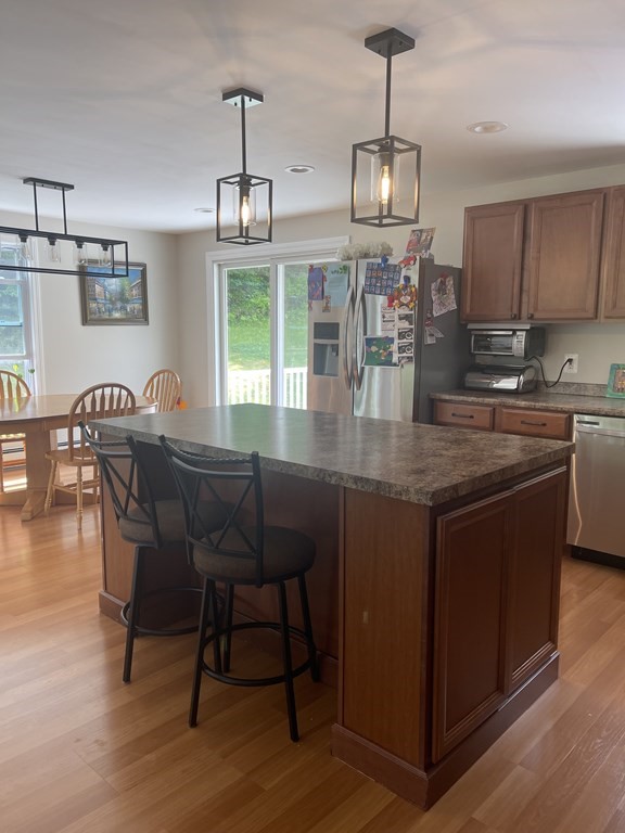 146 Old Ashby Road Ashburnham, MA 01430 - Photo 23 of 26 a dining room with furniture a chandelier and wooden floor
