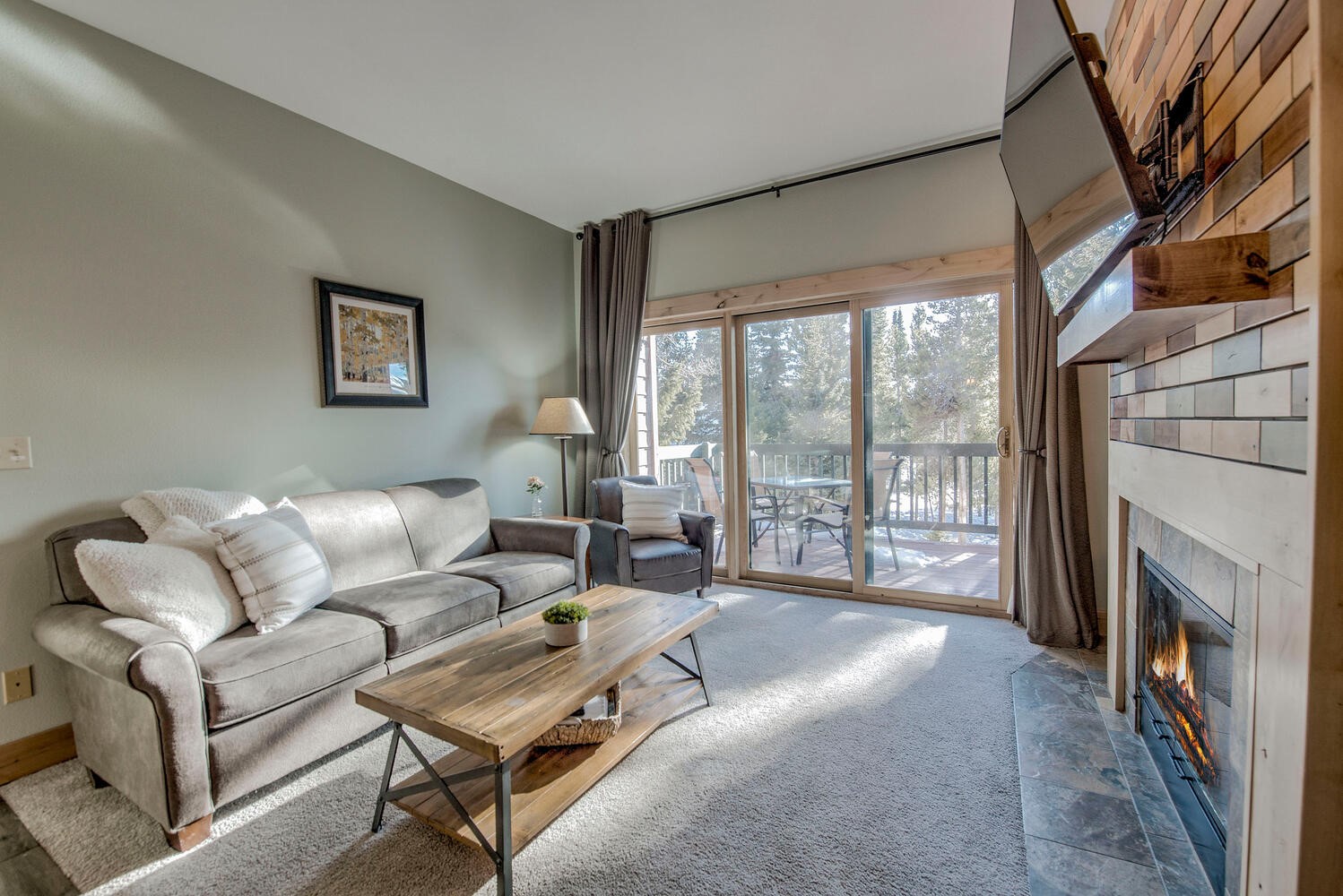 41 Washington Lode Breckenridge, CO 80424 - Photo 2 of 35 a living room with furniture a fireplace and a floor to ceiling window