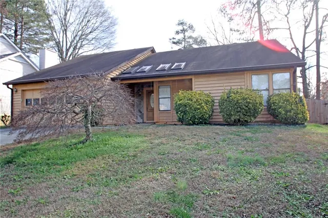 a front view of a house with garden