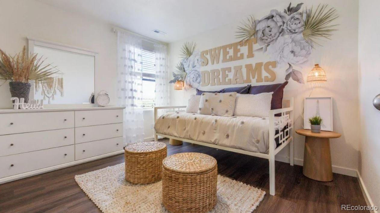 831 South Apex Avenue Fort Lupton, CO 80621 - Photo 13 of 18 a bedroom with a bed and a mirror on the dresser