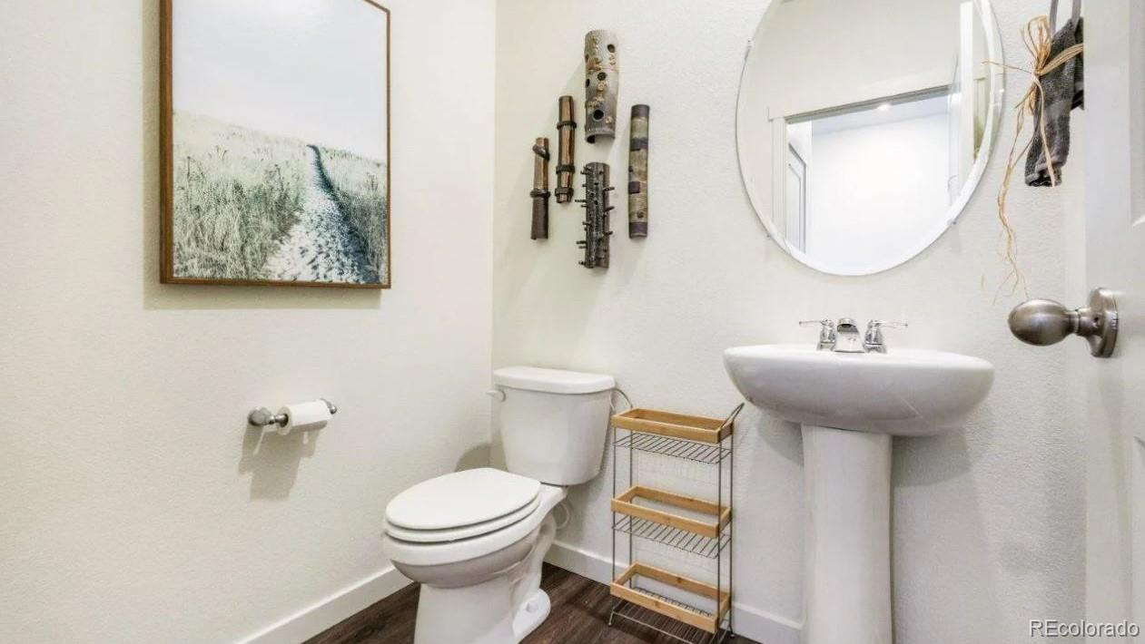 831 South Apex Avenue Fort Lupton, CO 80621 - Photo 15 of 18 a bathroom with a toilet a sink and mirror