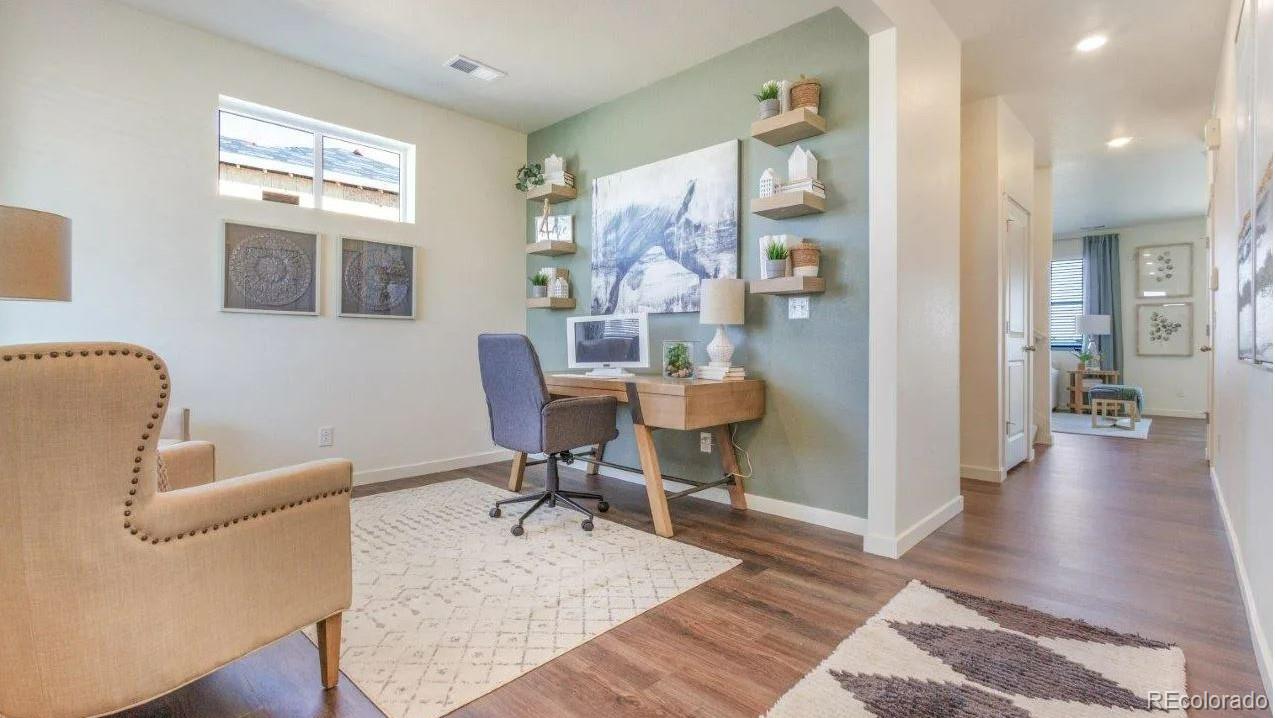 831 South Apex Avenue Fort Lupton, CO 80621 - Photo 3 of 18 a living room with furniture and a table