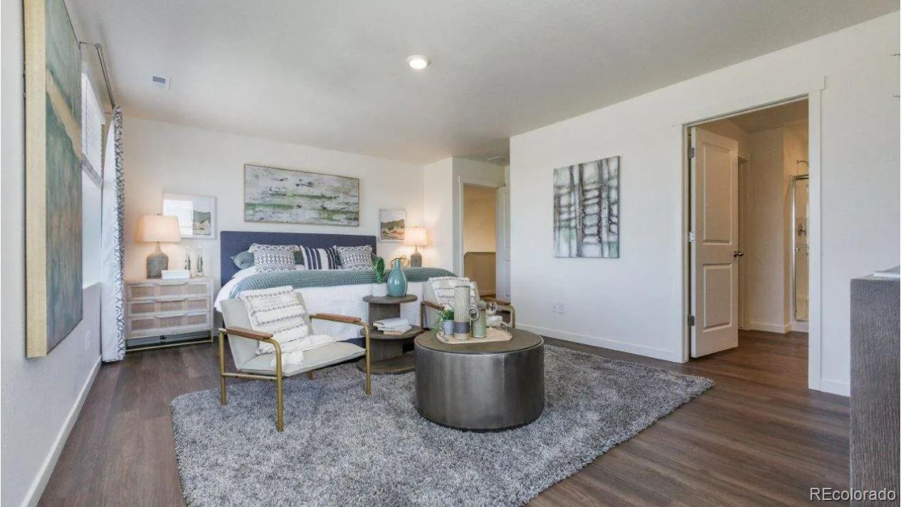 831 South Apex Avenue Fort Lupton, CO 80621 - Photo 9 of 18 a bedroom with furniture and a potted plant