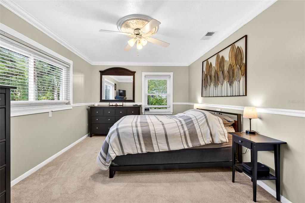 16330 Hanna Road Lutz, FL 33549 - Photo 21 of 41 a spacious bedroom with a bed and a large window