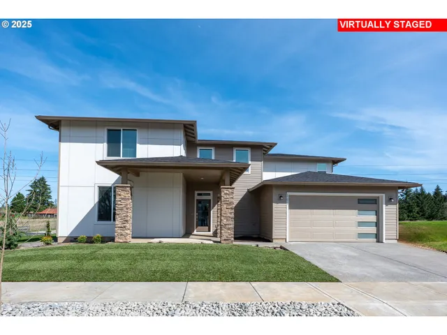 a front view of a house with a yard and garage