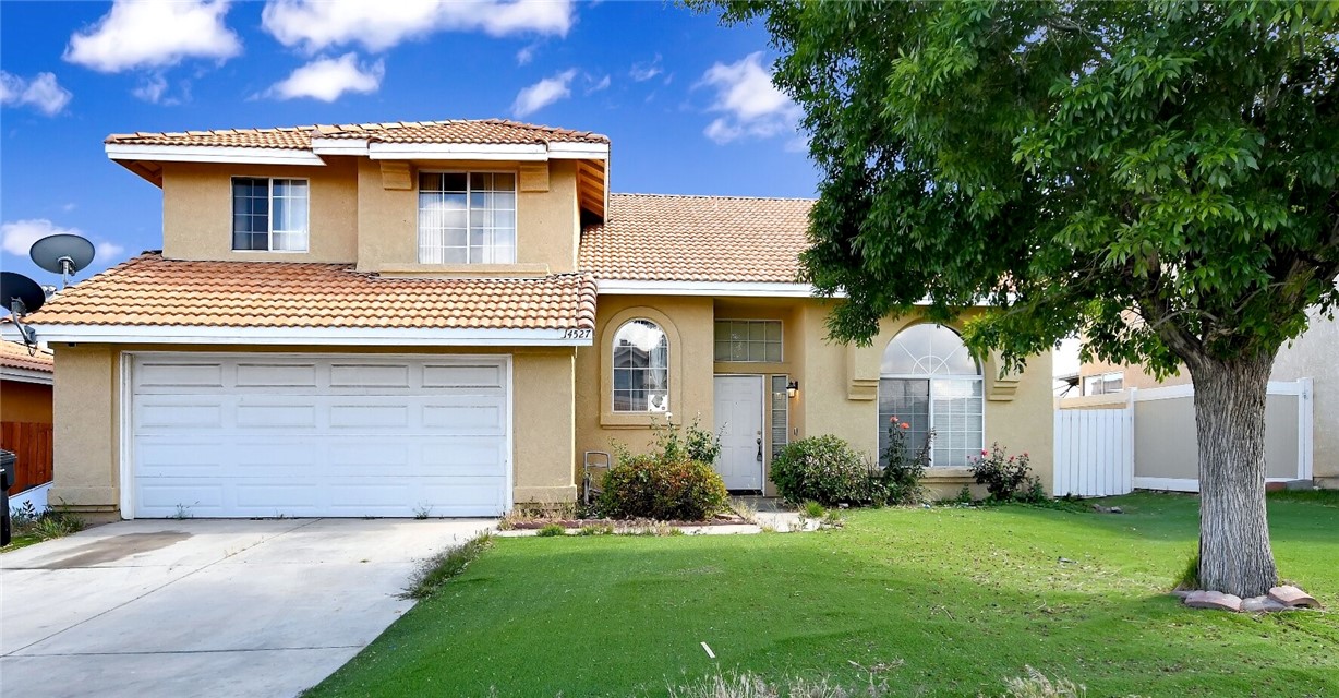 14527 Pony Trail Road Victorville, CA 92392 - Photo 1 of 21 a white house that has a small yard and large trees