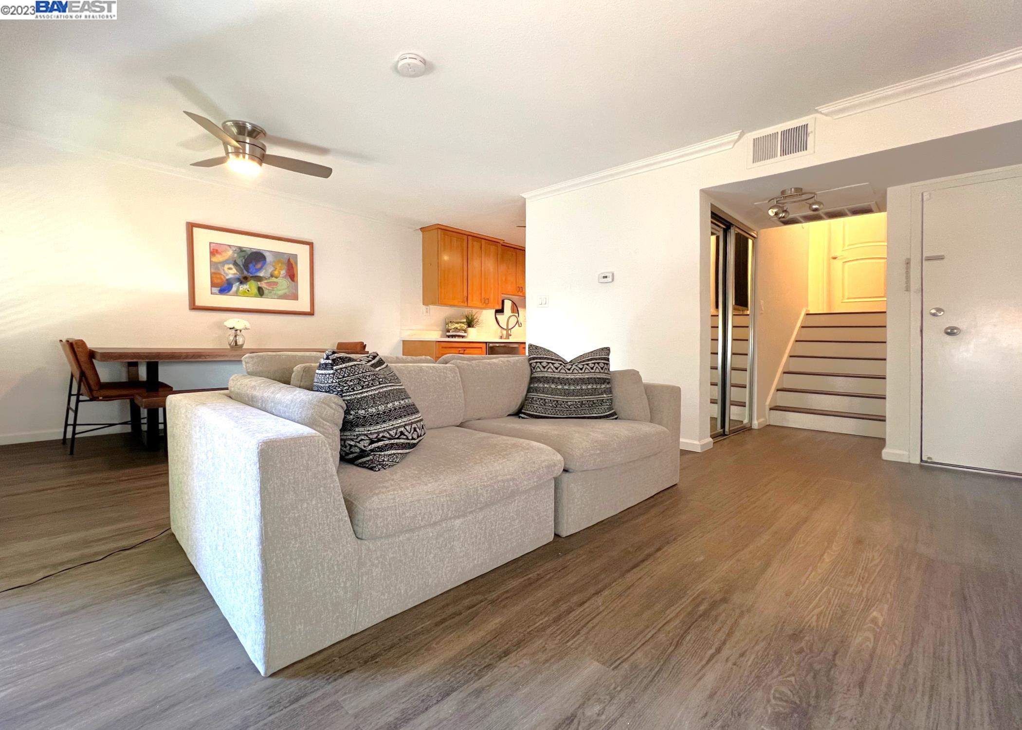 2724 Oak Road, Unit 92 Walnut Creek, CA 94597 - Photo 1 of 1 a living room with furniture and a wooden floor