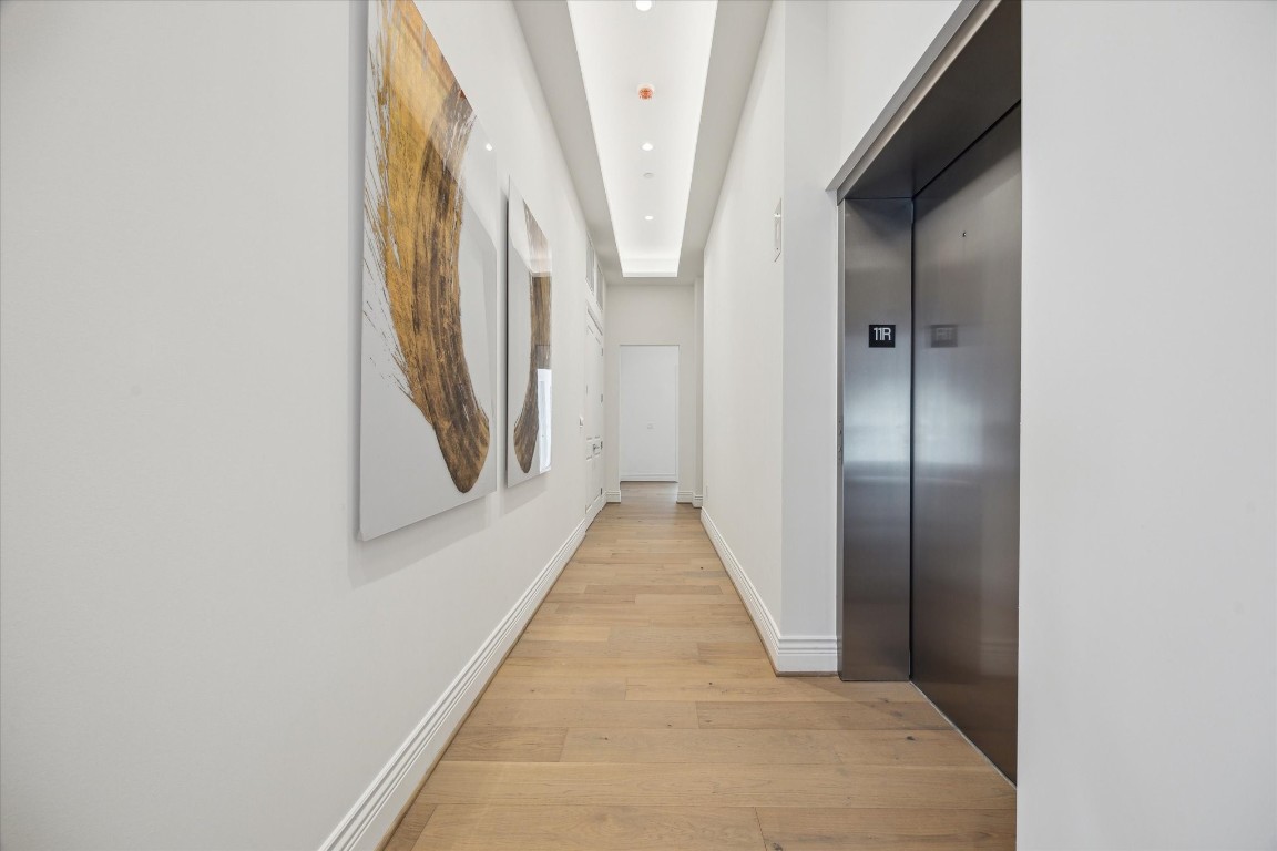 2323 San Felipe Street, Unit 1101 Houston, TX 77019 - Photo 12 of 24 a view of a hallway with wooden floor and staircase