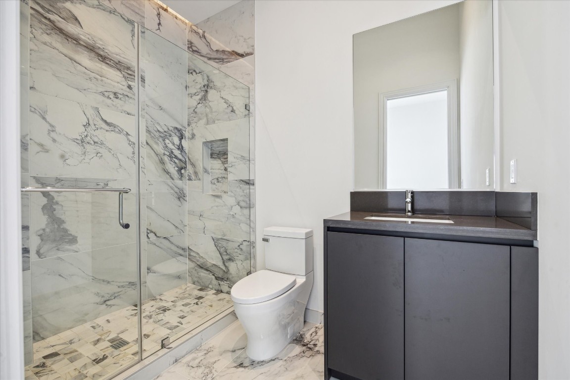 2323 San Felipe Street, Unit 1101 Houston, TX 77019 - Photo 14 of 24 a bathroom with a granite countertop sink toilet and shower