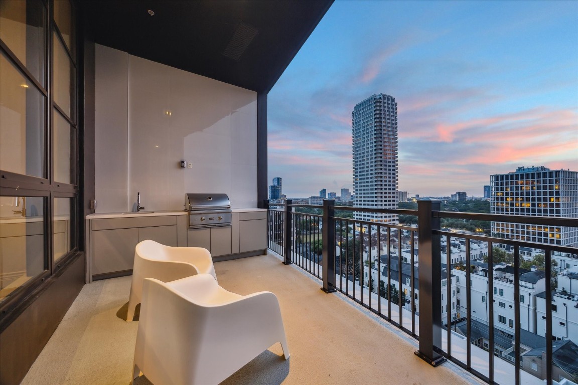 2323 San Felipe Street, Unit 1101 Houston, TX 77019 - Photo 16 of 24 a balcony with furniture and a floor to ceiling window