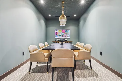 a kitchen with stainless steel appliances granite countertop a sink dishwasher and a dining table with wooden floor