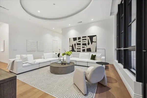 a living room with furniture kitchen and a table