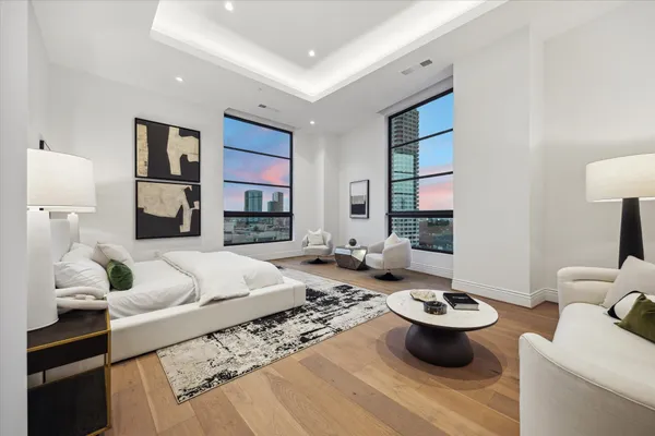 a living room with furniture a rug and a lamp