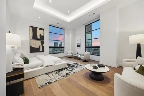 a living room with furniture a rug and a lamp