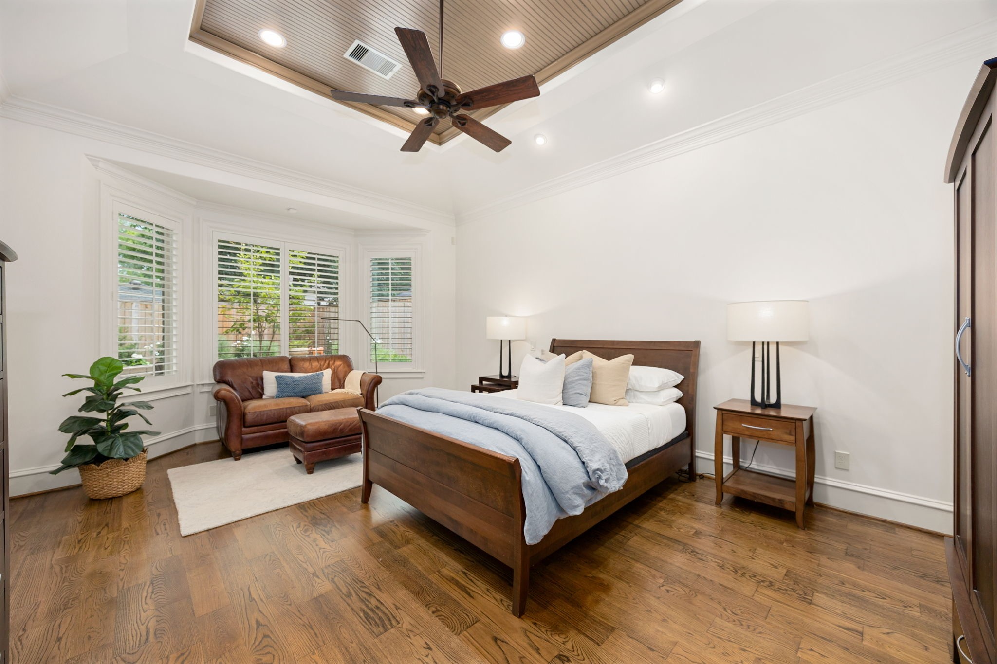 13310 Apple Tree Road Houston, TX 77079 - Photo 12 of 50 Spacious Primary bedroom has a tray ceiling, plantation shutters and a door that leads to the backyard and a seating area.