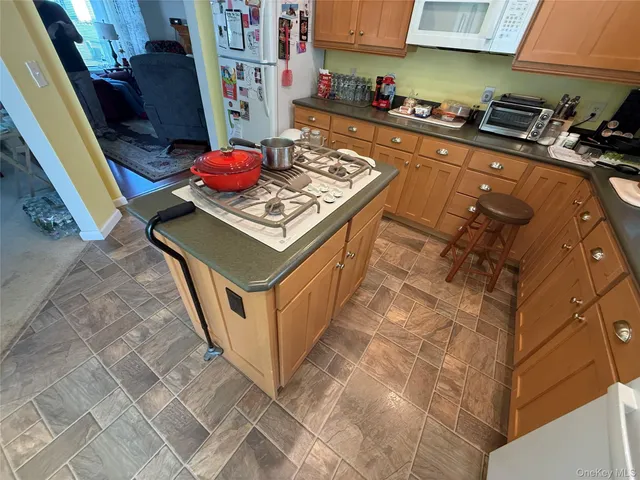 a white stove top oven sitting inside of a kitchen