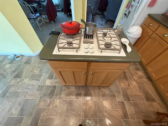 a kitchen with a refrigerator sink and white cabinets