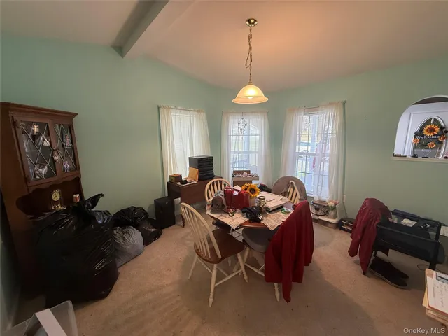 a dinning room with furniture and a chandelier