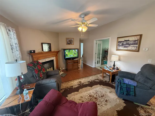 a living room with furniture a fireplace and a flat screen tv